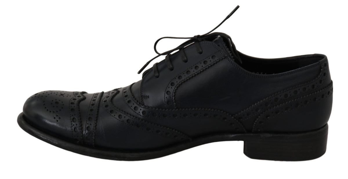 Sort snøresko set fra siden med dekorative perforeringer og brogue-detaljer.