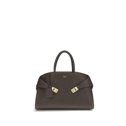 Sleek Ferragamo brown calf leather shoulder bag with gold hardware and bow strap