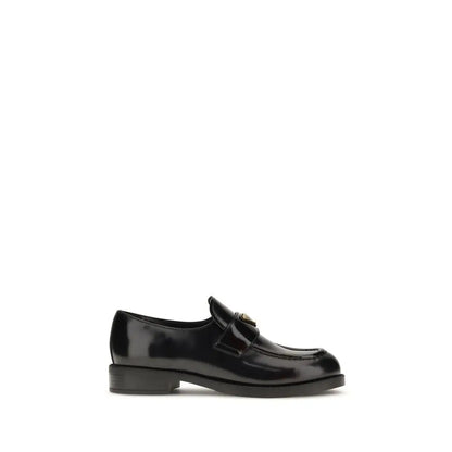 Prada black calf leather Bos Taurus slip-on loafers with patent finish and gold logo
